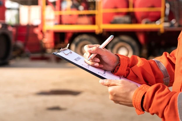 Fire safety inspection checklist near a fire engine
