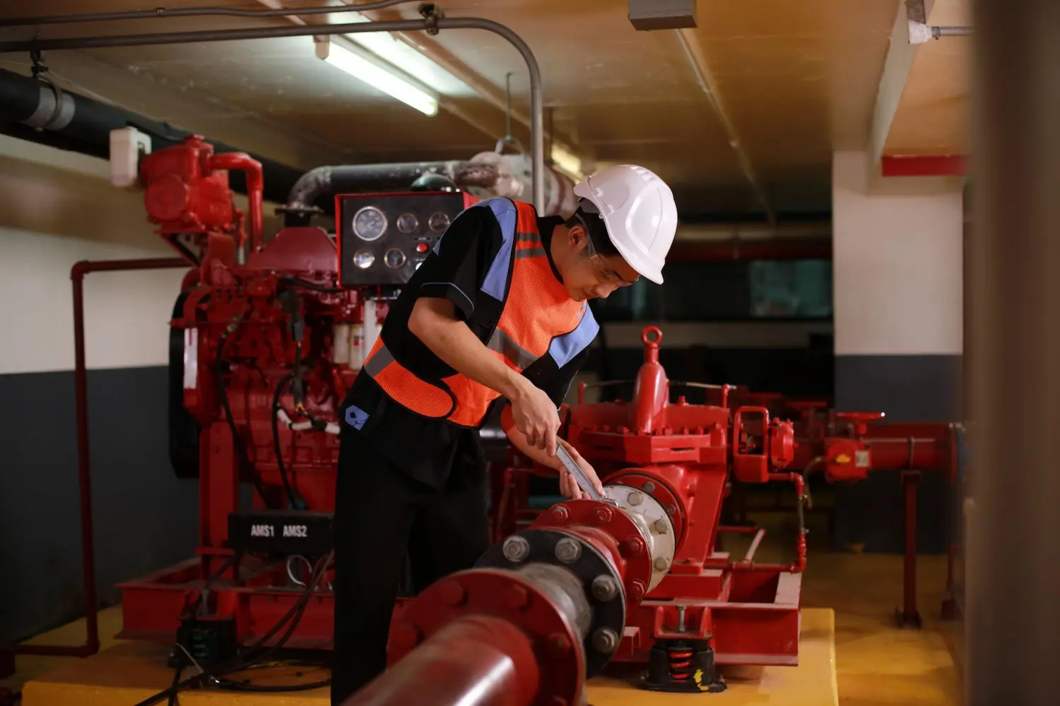 Fire service technician working on fire protection equipment