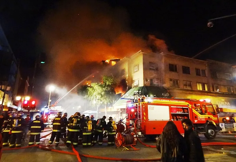Firefighters attending a building fire at night